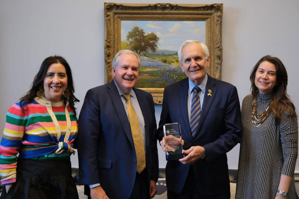 Lloyd Doggett (center right) accepts the THAT award from THA President/CEO John Hawkins (center left), Carrie Kroll (left) and Cameron Krier Massey (right)